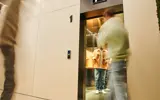 Adult Waits In Elevator With Coffee Cups 2026 03 11 06 56 22 Utc
